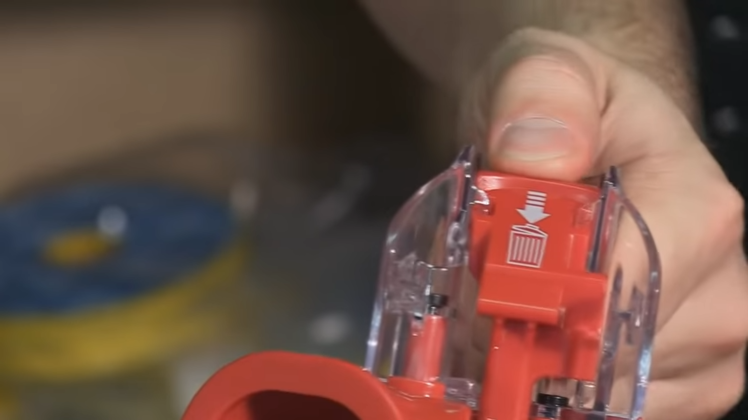 Press the button at the top of the canister, then press the bin-release assembly and gently pull the canister away