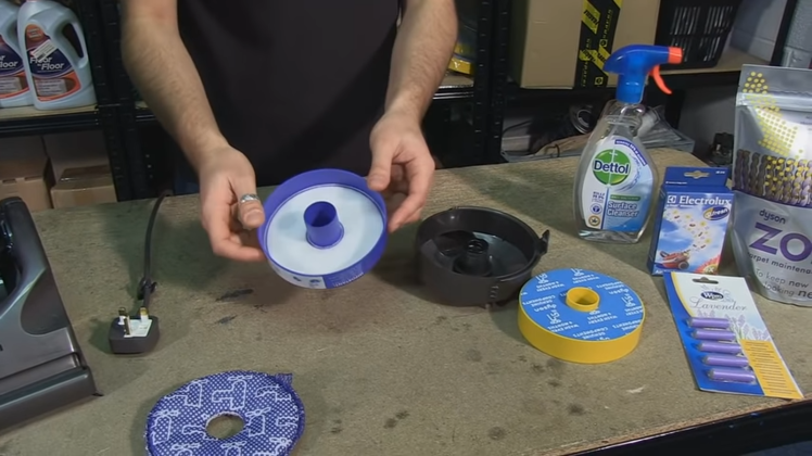 Wash the pre-motor filter case under cold water and tap it to remove any trapped dirt or debris