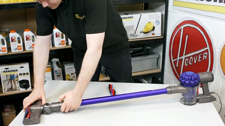 Press down the switch at the end of the vacuum wand and pull the motorhead out