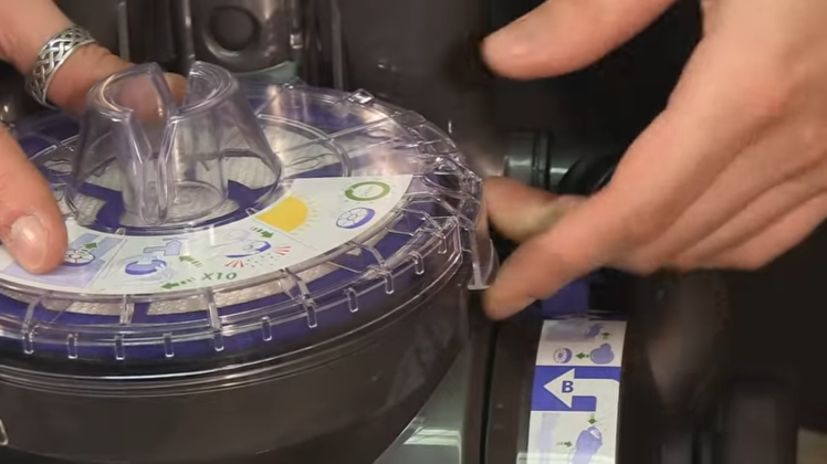 Press on the catch that is holding the post-motor filter in place, lift the lid and take the filter out