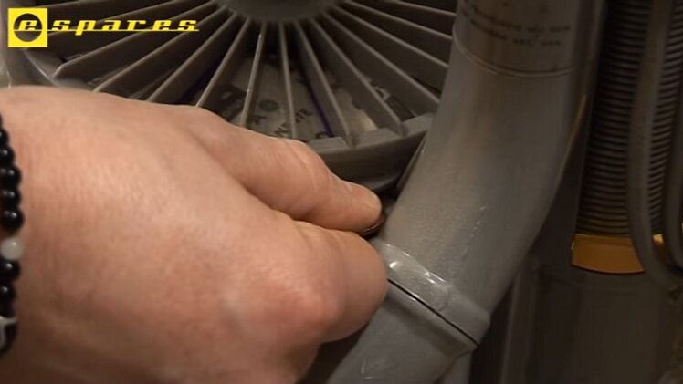 To access the post-motor filter, push a two-pence coin between the lips on the side of the storage compartment and twist the coin to pop it open
