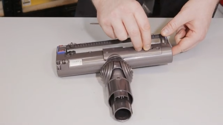 Refit the drive assembly cover and seal it in place by refitting the two screws