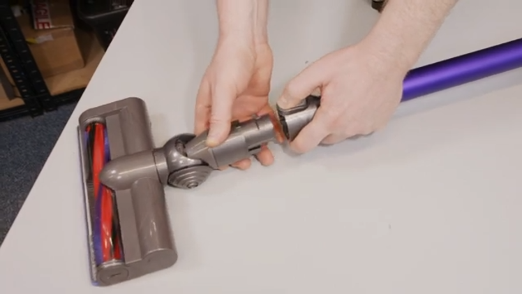 Press down on the button that attaches the motorhead to the wand and gently pull it away
