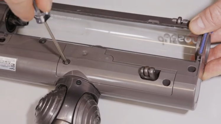 Use a very small Torx head screwdriver to remove the cover at the bottom of the motorhead by removing the two screws at either side