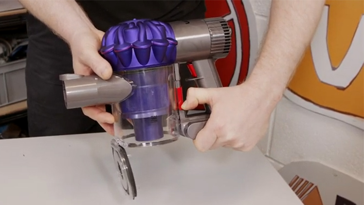 Push down on the red catch once to release the flap at the bottom and then again to release the bin itself