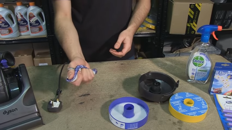 Rinse the pre-motor filter sponge under cold water, then squeeze it to release any excess water