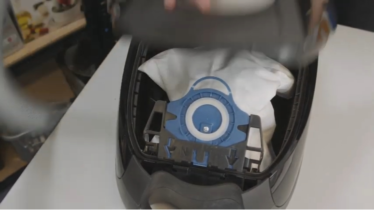 Tuck the new vacuum bag securely into the vacuum and close the cover