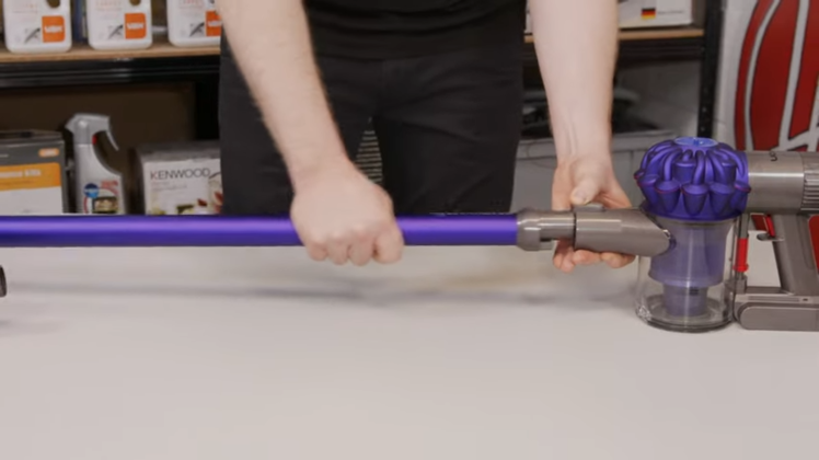 Press on the grey buttons at each end of the wand and gently pull it away