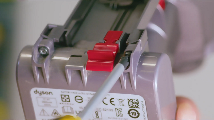 Refit the two screws you removed from the bottom earlier on either side of the red bin release tab.
